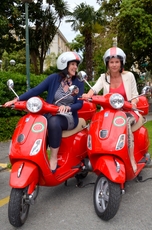 Barbara and Christine on their red Vespas in Liguria