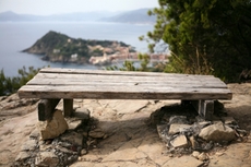 A wooden bench to take a rest with a beautiful view at the peninsula of Sestri Levante